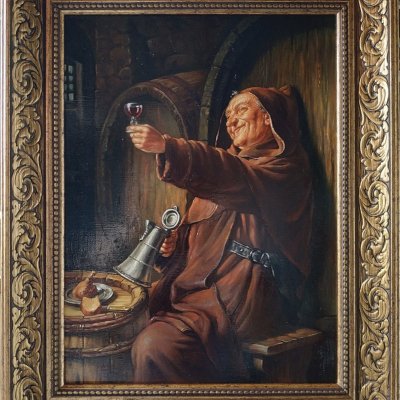 A monk with a glass of wine.
