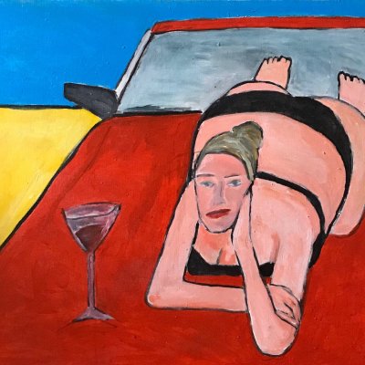 Girl with a glass of wine, sunbathing on the hood of a red car