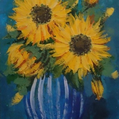 Yellow flowers in a blue vase.